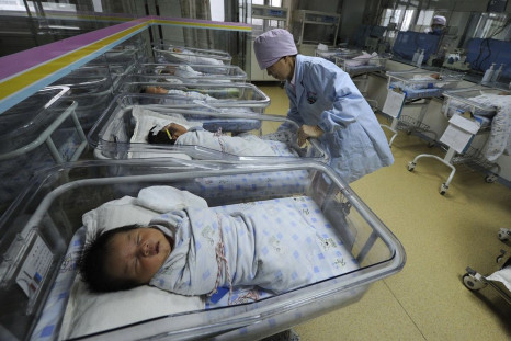A nurse takes care of newborn babies at a hospital in Hefei, Anhui province April 21, 2011.