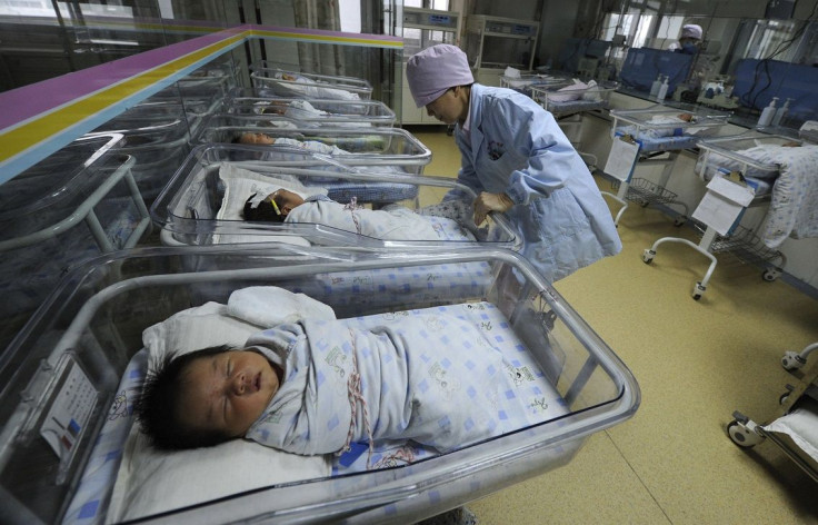 A nurse takes care of newborn babies at a hospital in Hefei, Anhui province April 21, 2011.