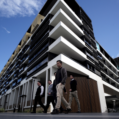 Sydney residents walk past a newly-completed apartment development in Sydney's inner-city suburb of Zetland, June 24, 2015.