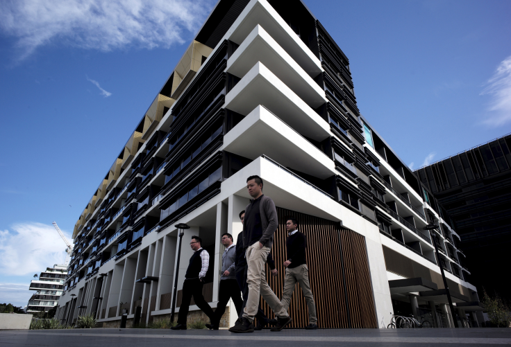 Sydney residents walk past a newly-completed apartment development in Sydney's inner-city suburb of Zetland, June 24, 2015.