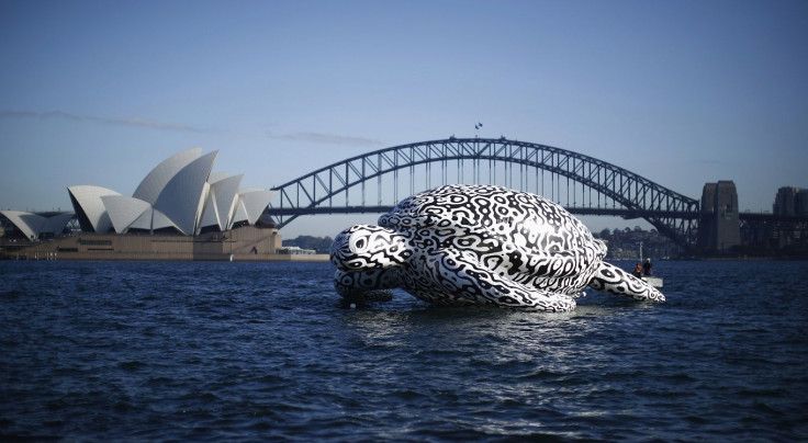 A floating sculpture named 'Alpha Turtle' is pictured in front of the Sydney Opera House and Harbour Bridge, August 15, 2014.