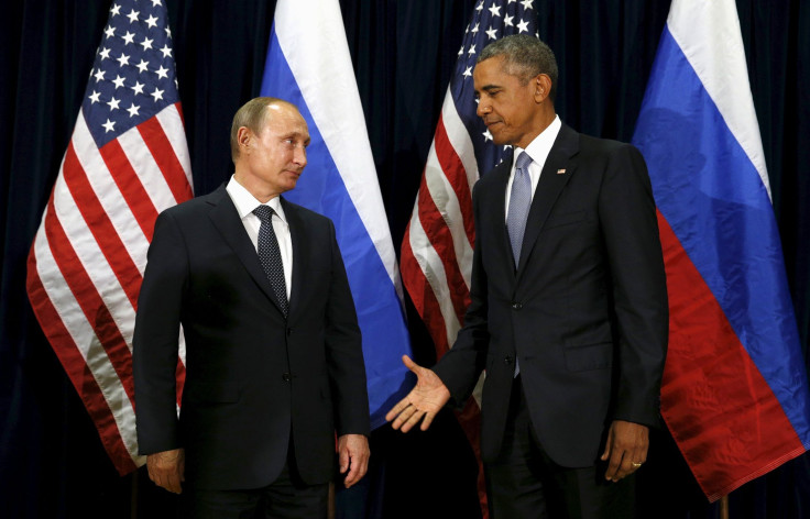 U.S. President Barack Obama extends his hand to Russian President Vladimir Putin