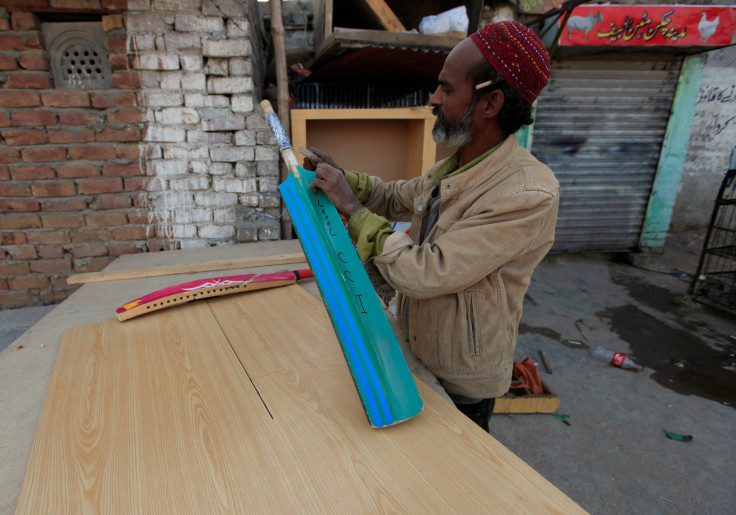 A carpenter repairs a cricket bat at his workshop in Islamabad, Pakistan, February 22, 2017.