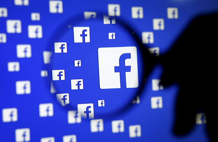 A man poses with a magnifier in front of a Facebook logo on display in this illustration taken in Sarajevo, Bosnia and Herzegovina, December 16, 2015