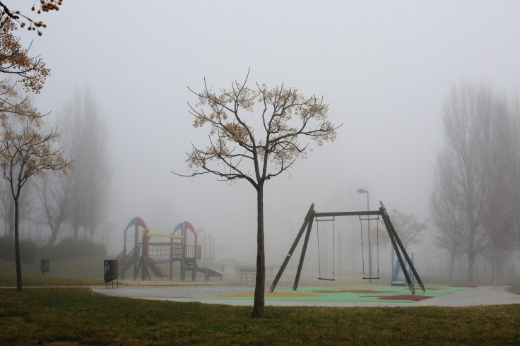 Fog surrounds a playground at a public park in Parla, south of Madrid, January 15, 2014.