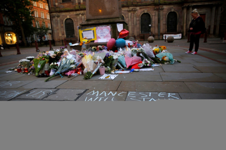 A woman looks at flowers for the victims of the Manchester Arena attack, in central Manchester Britain May 23, 2017.