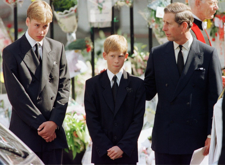 Prince Charles (R) puts his hand on Prince Harry's (C) shoulder as Prince William looks on after the coffin of Diana, Princess of Wales, was placed into a hearse September 6.