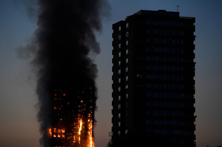 Flames and smoke billow as firefighters deal with a serious fire in a tower block at Latimer Road in West London, Britain June 14, 2017.