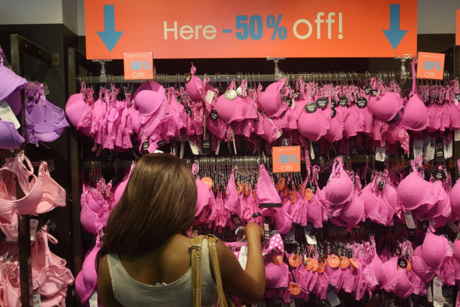 A woman looks at underwear in a store with discount signs during the second day of summer sales in Brussels July 2, 2014.