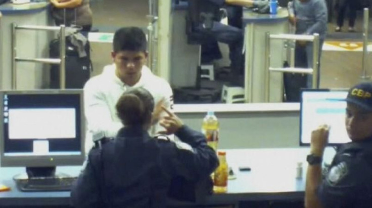 Mexican teenager Cruz Velazquez Acevedo speaks with an officer while holding a bottle containing liquid methamphetamine at a U.S. border control point in San Ysidro, California, U.S. in a still image from surveillance video recorded November 18, 2013.