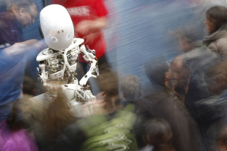 Visitors look at the humanoid robot Roboy at the exhibition 'Robots on Tour' in Zurich, March 9, 2013.