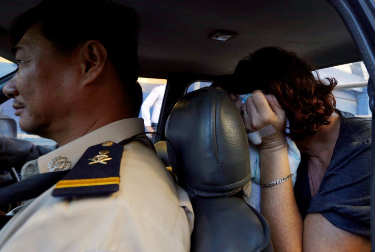 Australia's Tammy Davis-Charles (R), sits in a police vehicle after appearing for a questioning at the Municipal Court of Phnom Penh, Cambodia November 21, 2016.