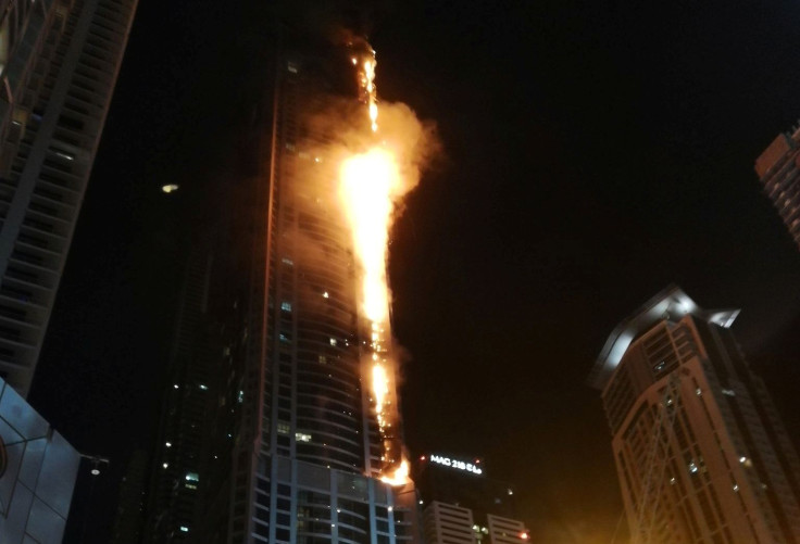 Flames shoot up the sides of the Torch tower residential building in the Marina district, Dubai, United Arab Emirates, in this August 4, 2017 picture by Mitch Williams.