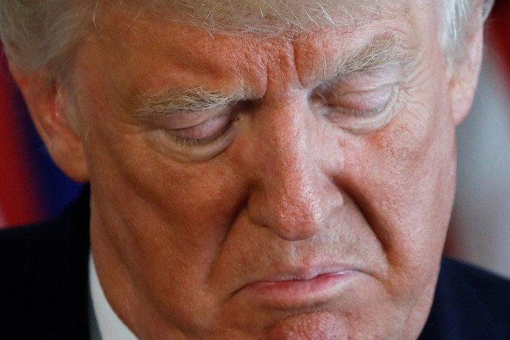 U.S. President Donald Trump winces while delivering remarks on the protests in Charlottesville, Virginia, from his golf estate in Bedminster, New Jersey, U.S. August 12, 2017.