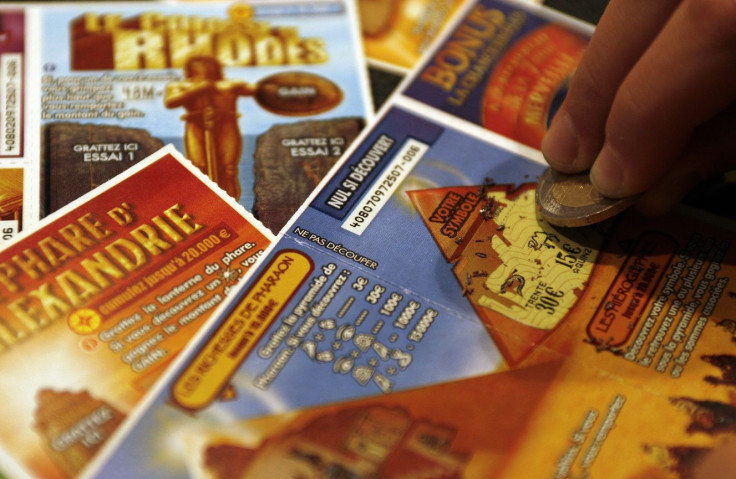 A customer scratches a lottery ticket at a tobacconist shop in Marseille, December 1, 2007.
