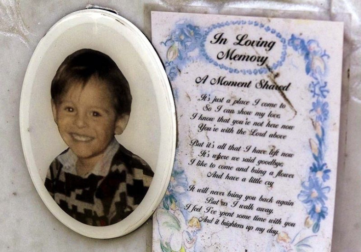 A message lies behind a picture of murdered toddler James Bulger at his grave in Kirkdale Cemetery, Liverpool, June 22, 2001.