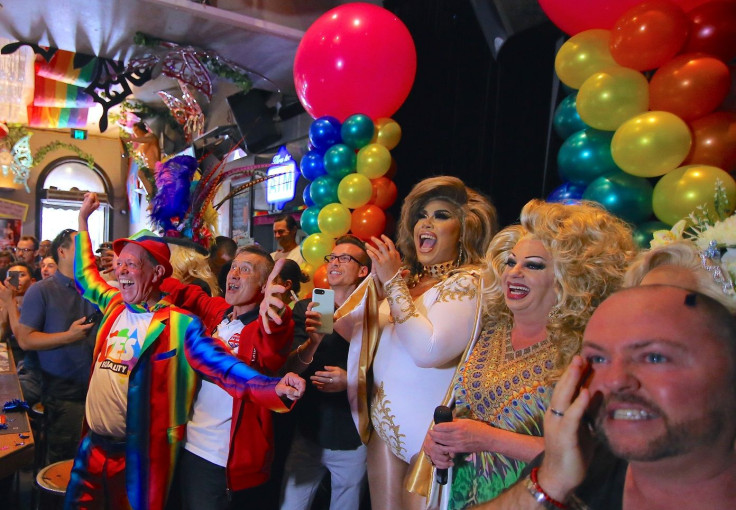 Members of Sydney's gay community react as they celebrate after it was announced the majority of Australians support same-sex marriage