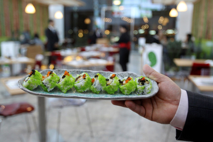 A man carries a plate of Arabic Sushi at Cactus Senshi restaurant in Doha, Qatar October 8, 2016. Picture taken October 8, 2016.