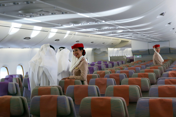 FILE PHOTO: Emirates cabin crew look on as visitors tour an Emirates Airbus A380 during the Dubai Airshow in Dubai, United Arab Emirates November 13, 2017.