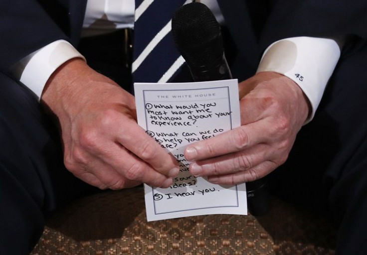 U.S. President Donald Trump  holds his prepared questions as he hosts a listening session with high school students and teachers to discuss school safety at the White House in Washington, U.S., February 21, 2018.