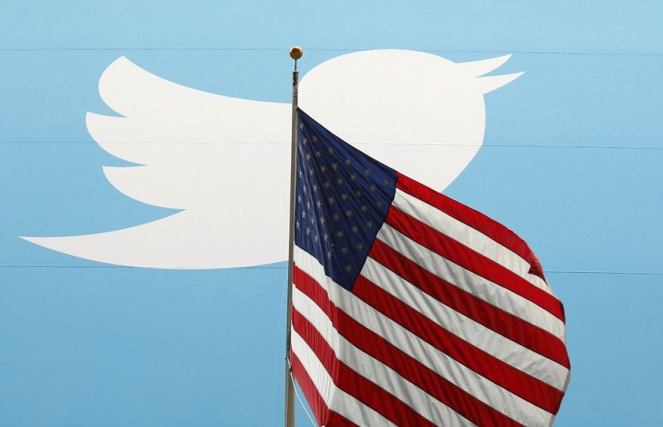 The Twitter Inc. logo is shown with the U.S. flag during the company's IPO on the floor of the New York Stock Exchange in New York, November 7, 2013.