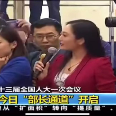 Yicai.com's Liang Xiangyi rolls her eyes as Zhang Huijun asks questions at China's annual parliamentary session