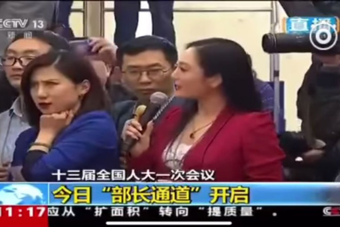 Yicai.com's Liang Xiangyi rolls her eyes as Zhang Huijun asks questions at China's annual parliamentary session