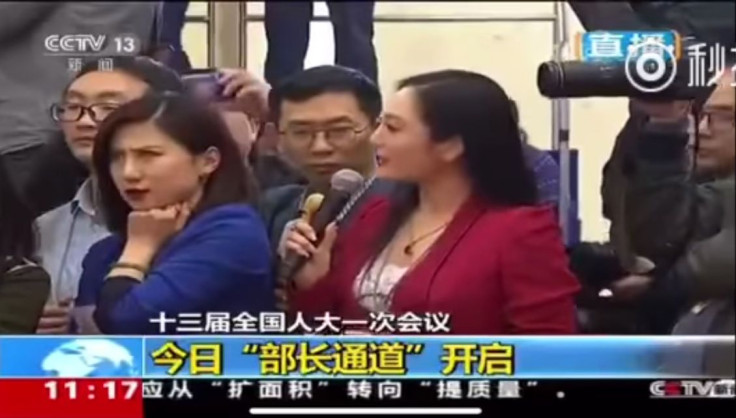 Yicai.com's Liang Xiangyi rolls her eyes as Zhang Huijun asks questions at China's annual parliamentary session