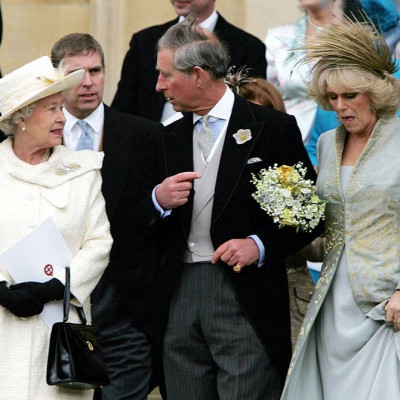 Queen Elizabeth stands behind Prince Charles and Camilla Parker Bowles
