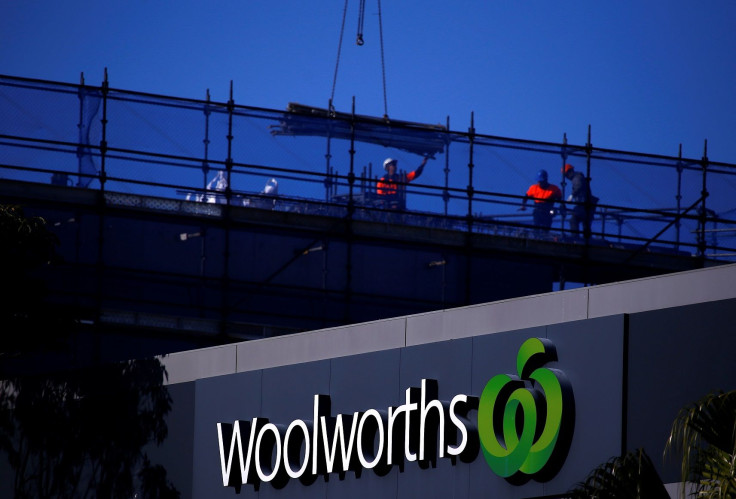 Workers can be seen on a building site behind a Woolworths Ltd supermarket, Australia's biggest grocery chain by sales, located in Sydney, Australia, August 23, 2017.