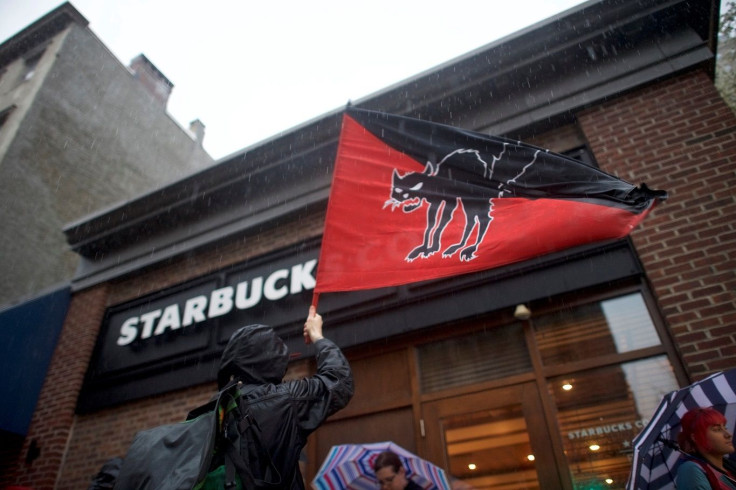 Donovan Dobbins, 34, waves a flag representing a workers strike outside a Center City Starbucks, where two black men were arrested, in Philadelphia, Pennsylvania U.S. April 16, 2018.