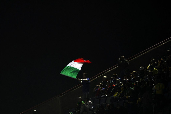 A fan waves the Italian national flag before his team take on Brazil in their Confederations Cup soccer match at the Loftus Versfeld stadium in Pretoria June 21, 2009.