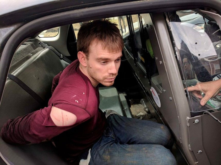 Travis Reinking, the suspect in a Waffle House shooting in Nashville, is under arrest by Metro Nashville Police Department in a wooded area in Antioch, Tennessee, U.S., April 23, 2018.