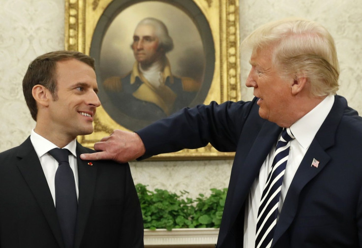 French President Emmanuel Macron (L) looks on as U.S. President Donald Trump