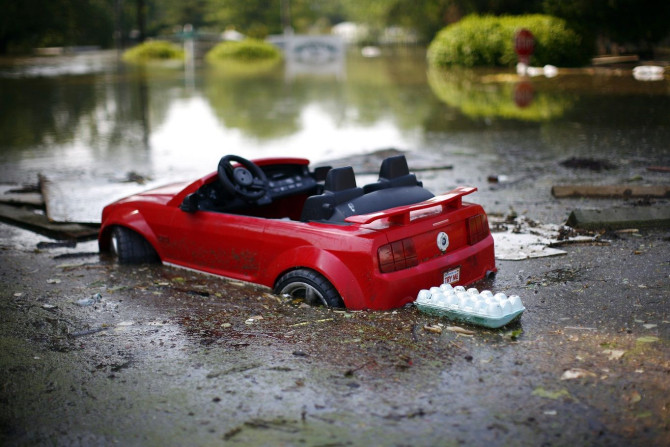 A toy car is seen partially submerged as floodwaters slowly rise in Memphis, Tennessee May 8, 2011.