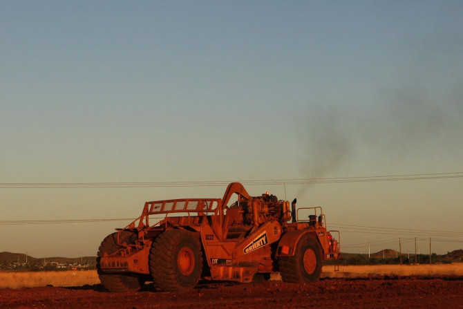 A man operates an earthmover in a new industrial area in Karratha at the Pilbarra region in Western Australia April 19, 2011. Picture taken April 19, 2011.