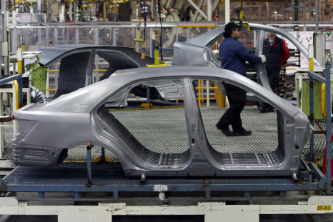 An Auto worker loads bodyshells of a Toyota Camry Hybrid car onto the assembly line at the Toyota plant in Melbourne August 31, 2009.