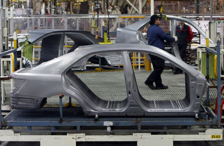 An Auto worker loads bodyshells of a Toyota Camry Hybrid car onto the assembly line at the Toyota plant in Melbourne August 31, 2009.