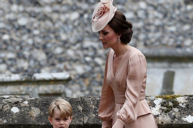 Catherine, Duchess of Cambridge, stands with Princess Charlotte and Prince George,