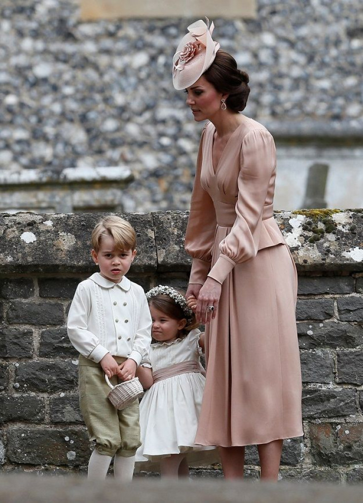 Catherine, Duchess of Cambridge, stands with Princess Charlotte and Prince George,
