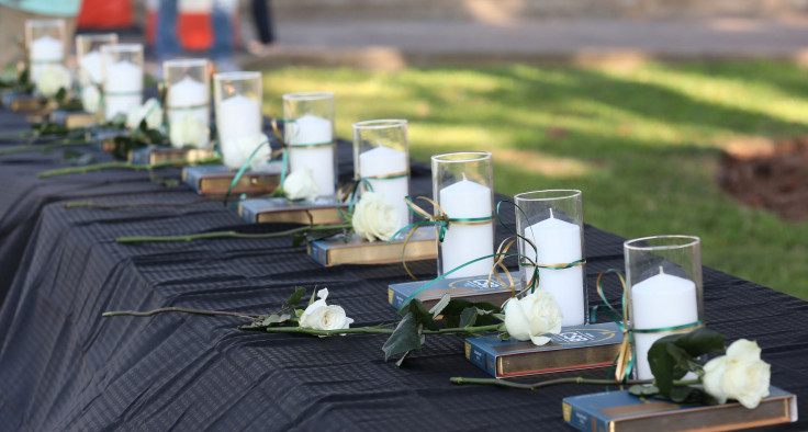 Candles line a table during a vigil held at the Texas First Bank after a shooting left several people dead at Santa Fe High School in Santa Fe, Texas, U.S., May 18, 2018.