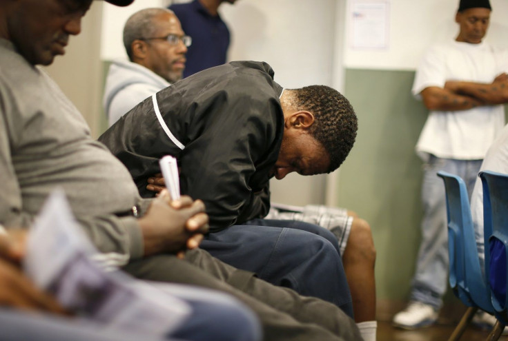 U.S. military veterans listen to speeches during a Veterans Day observance for homeless veterans at The Midnight Mission shelter on skid row in Los Angeles, California, November 11, 2013.