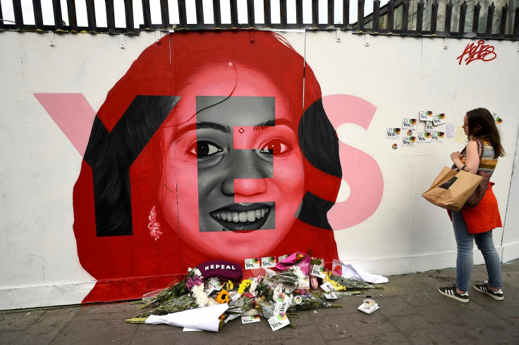 A woman looks at a new mural of Savita Halappanavar with flowers placed beneath it put up on the day of the Abortion Referendum on liberalising abortion laws in Dublin, Ireland May 25, 2018.