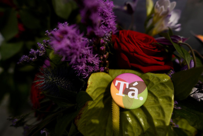 A badge with a message of 'Ta' in Irish language meaning 'Yes' in English is left with flowers at a memorial to Savita Halappanavar a day after an Abortion Referendum to liberalise abortion laws was passed by popular vote, in Dublin, Ireland May 27, 2018.
