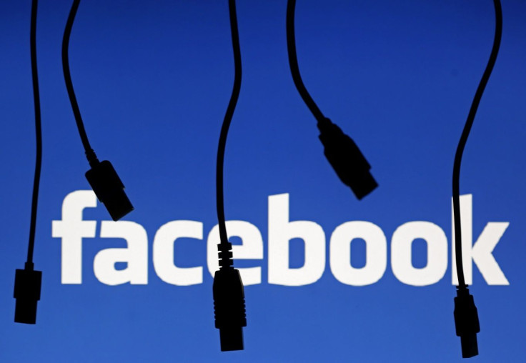 Electronic cables are silhouetted next to the logo of Facebook in this September 23, 2014 illustration photo in Sarajevo.