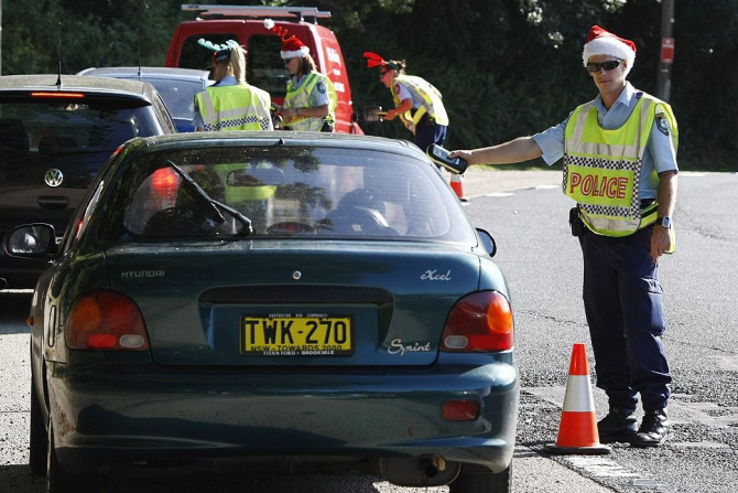 Police officers get into the spirit of Christmas day by wearing Christmas themed hats as they carry out random roadside breath tests on a Sydney street December 25, 2008.