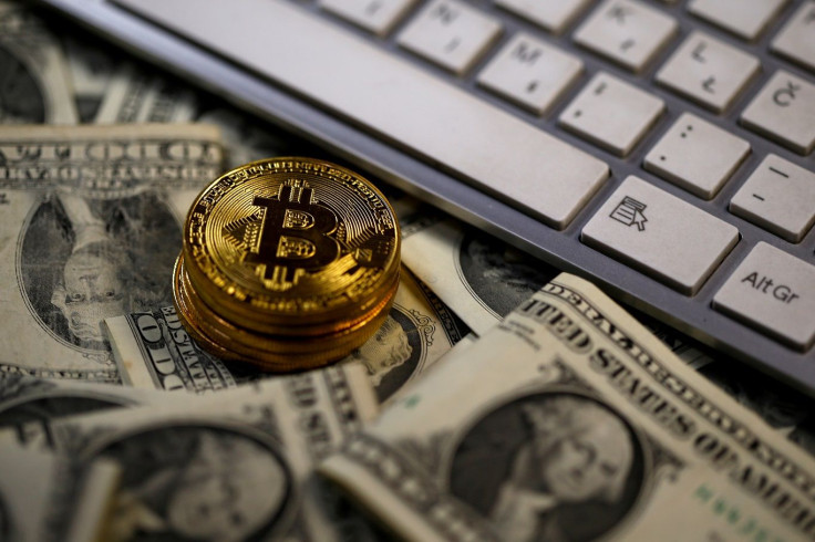 FILE PHOTO: Bitcoin (virtual currency) coins placed on Dollar banknotes, next to computer keyboard, are seen in this illustration picture, November 6, 2017.