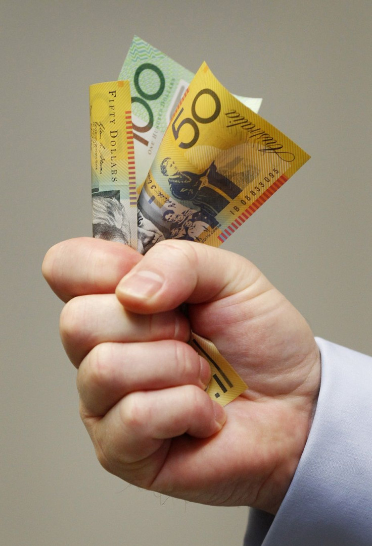 A man holds Australian banknotes in this photo illustration in Sydney May 8, 2012.