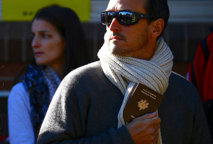 A French national living in Australia holds his passport