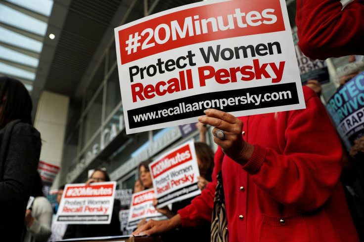 Activists hold signs calling for the removal of Judge Aaron Persky